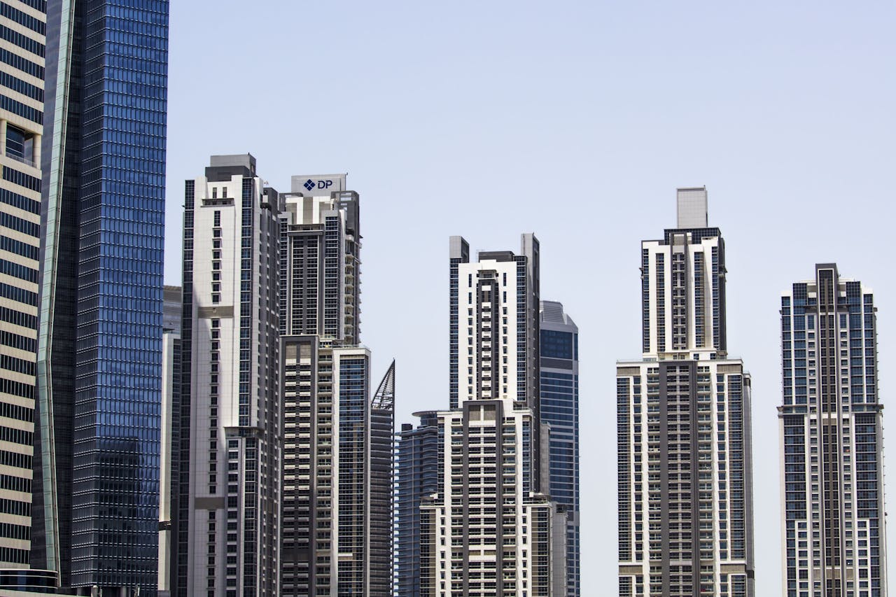 A striking view of modern skyscrapers in Dubai, showcasing urban architecture and a clear sky.